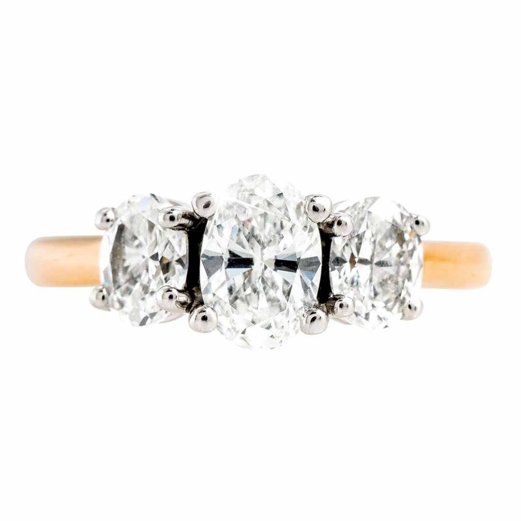 Yellow gold three-stone diamond engagement ring.