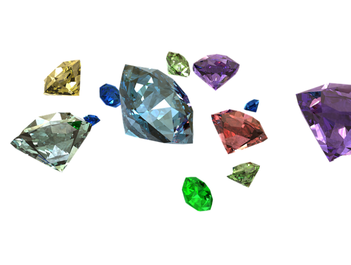 Several loose round cut naturally colored diamonds.