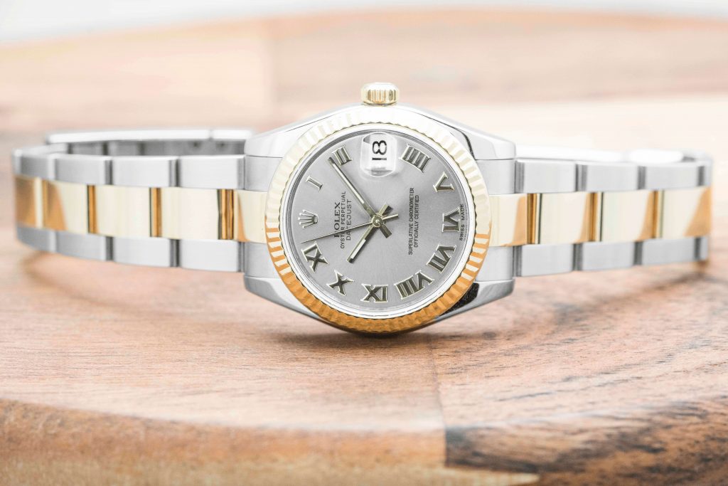 Pre-owned women’s Rolex Datejust in stainless steel and yellow gold with roman
numeral markers.