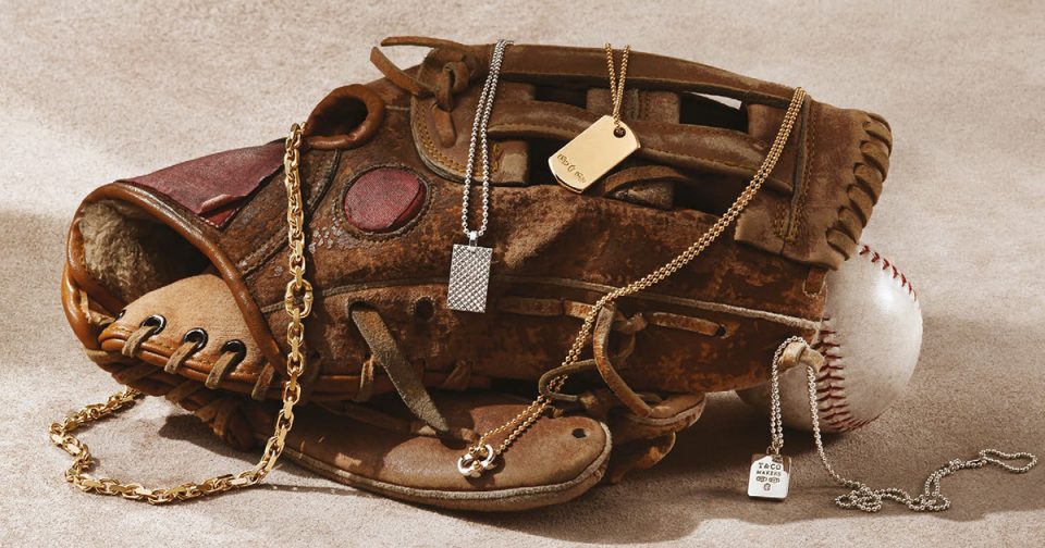 Baseball mitt layered with vintage Tiffany & Co. men’s dog tag necklaces and yellow gold chains.