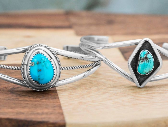 Two sterling silver split shank rings centered with turquoise.
