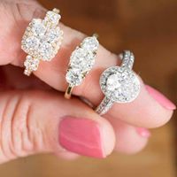three diamond engagement rings in womans finger