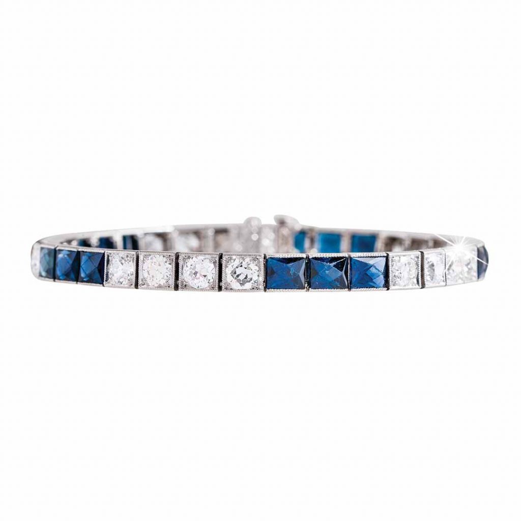 White gold tennis bracelet set with blue sapphires and diamonds.