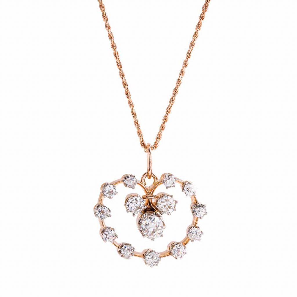 Rose gold open circle drop pendant necklace set with diamonds.