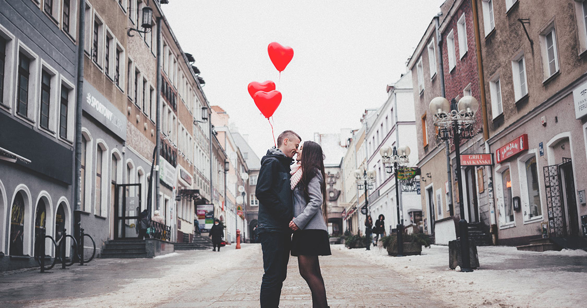 a couple kissing in the middle of a street