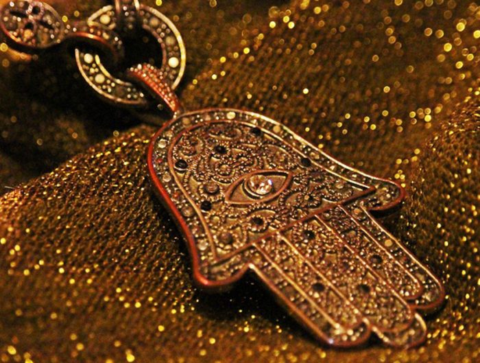 Close-up of Hamsa pendant.