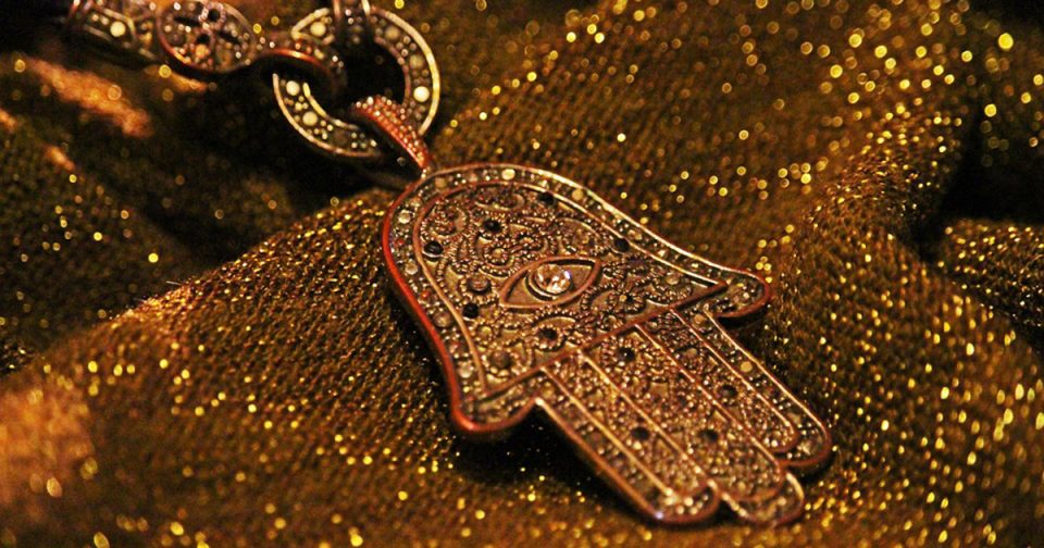 Close-up of Hamsa pendant.