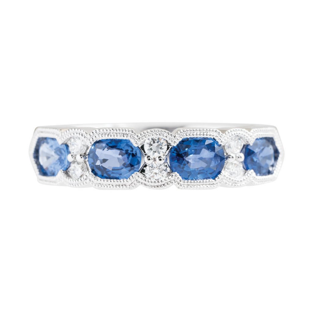 White gold ring set with blue sapphires and diamonds.