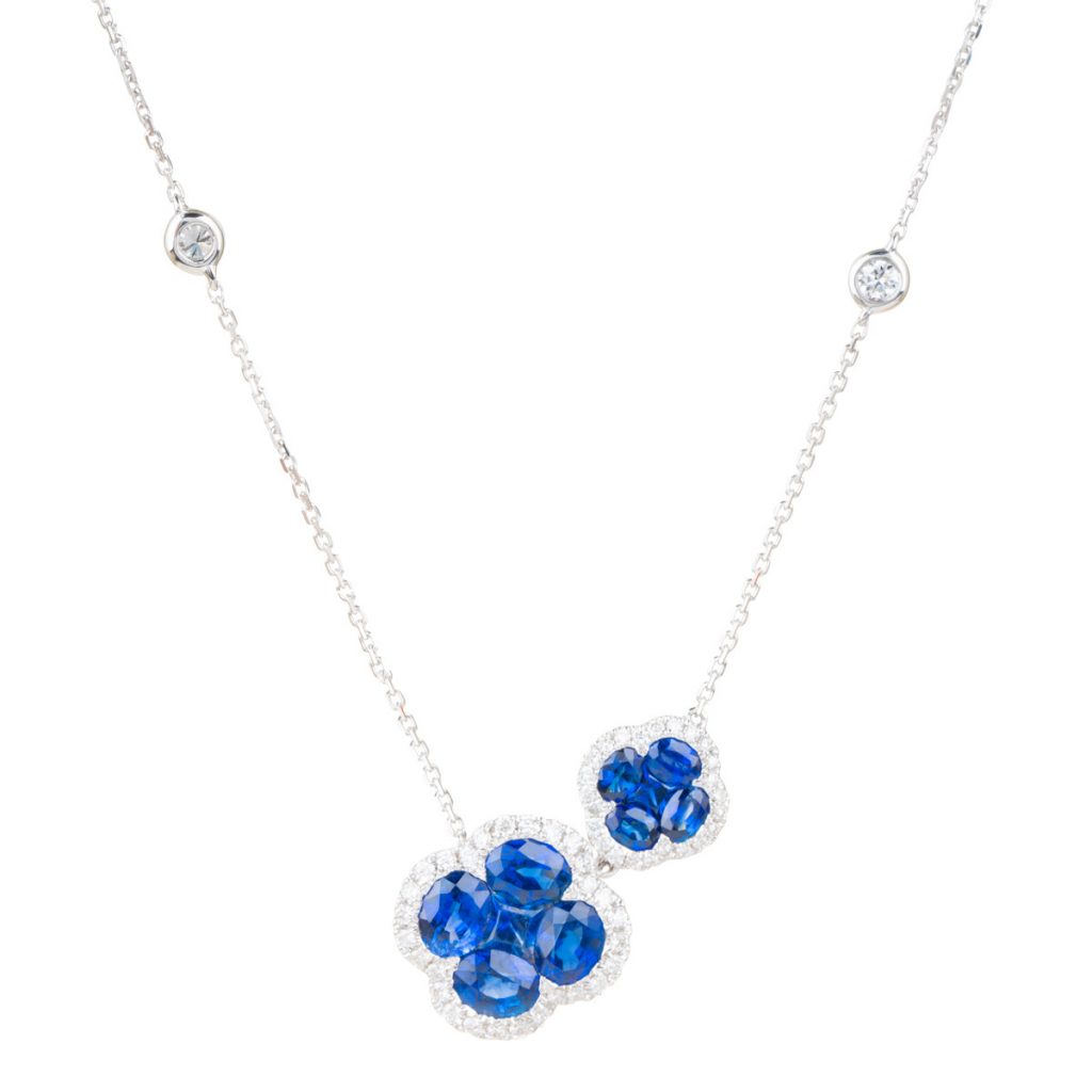 White gold double clover necklace set with blue sapphires and diamonds.