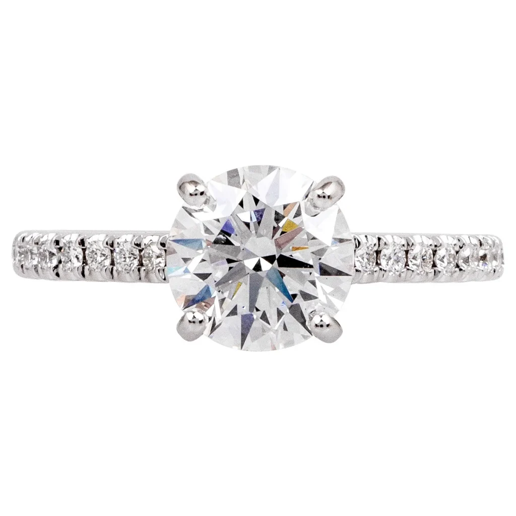 New white gold Venetti engagement ring centered with a round brilliant cut diamond and diamonds in the band.