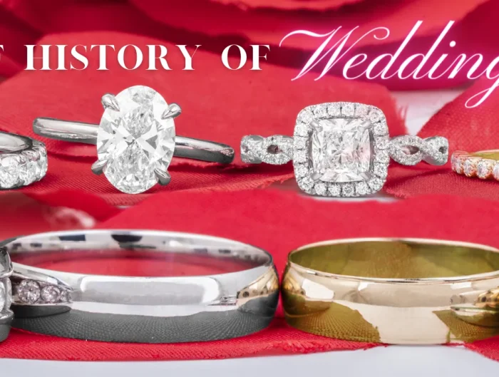 Various wedding and engagement rings on a red petal background with text “A Brief History of Wedding Rings”.