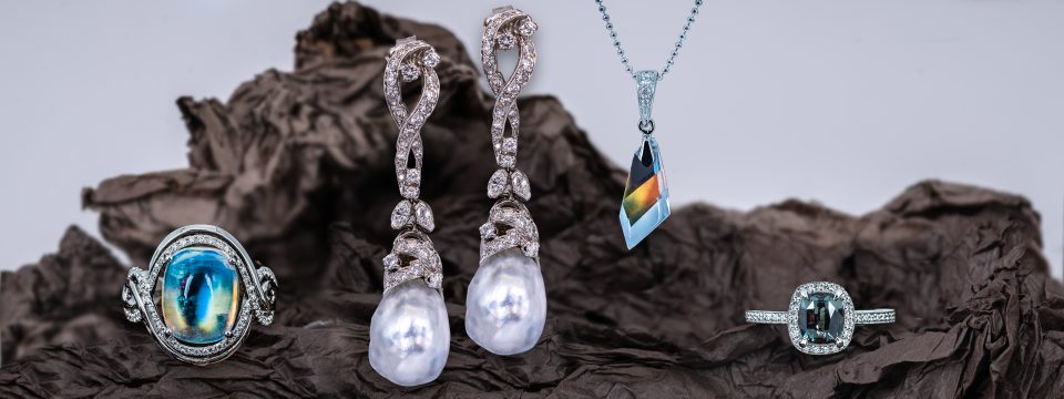 Moonstone and diamond ring, pearl and diamond drop earrings, moonstone and diamond pendant, and alexandrite and diamond ring.