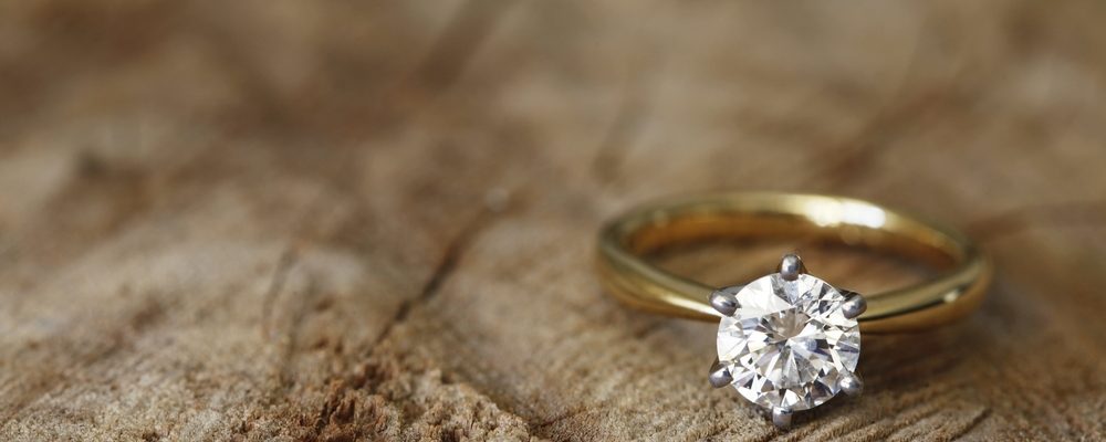 Yellow gold solitaire diamond engagement ring.