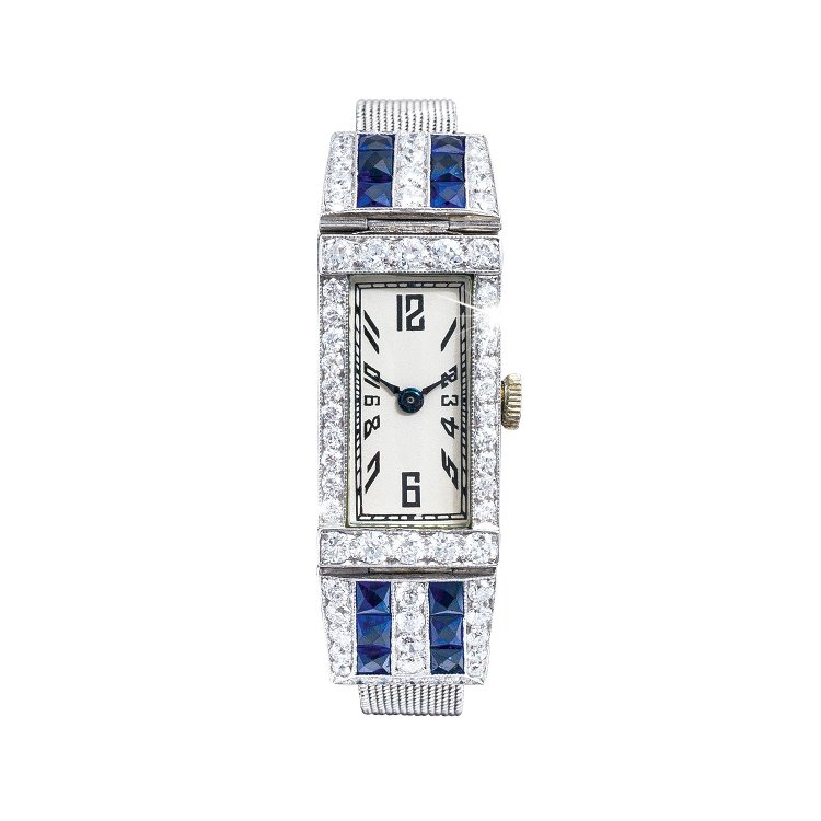 Antique pre-owned watch set with diamonds and blue gemstones in the bracelet.