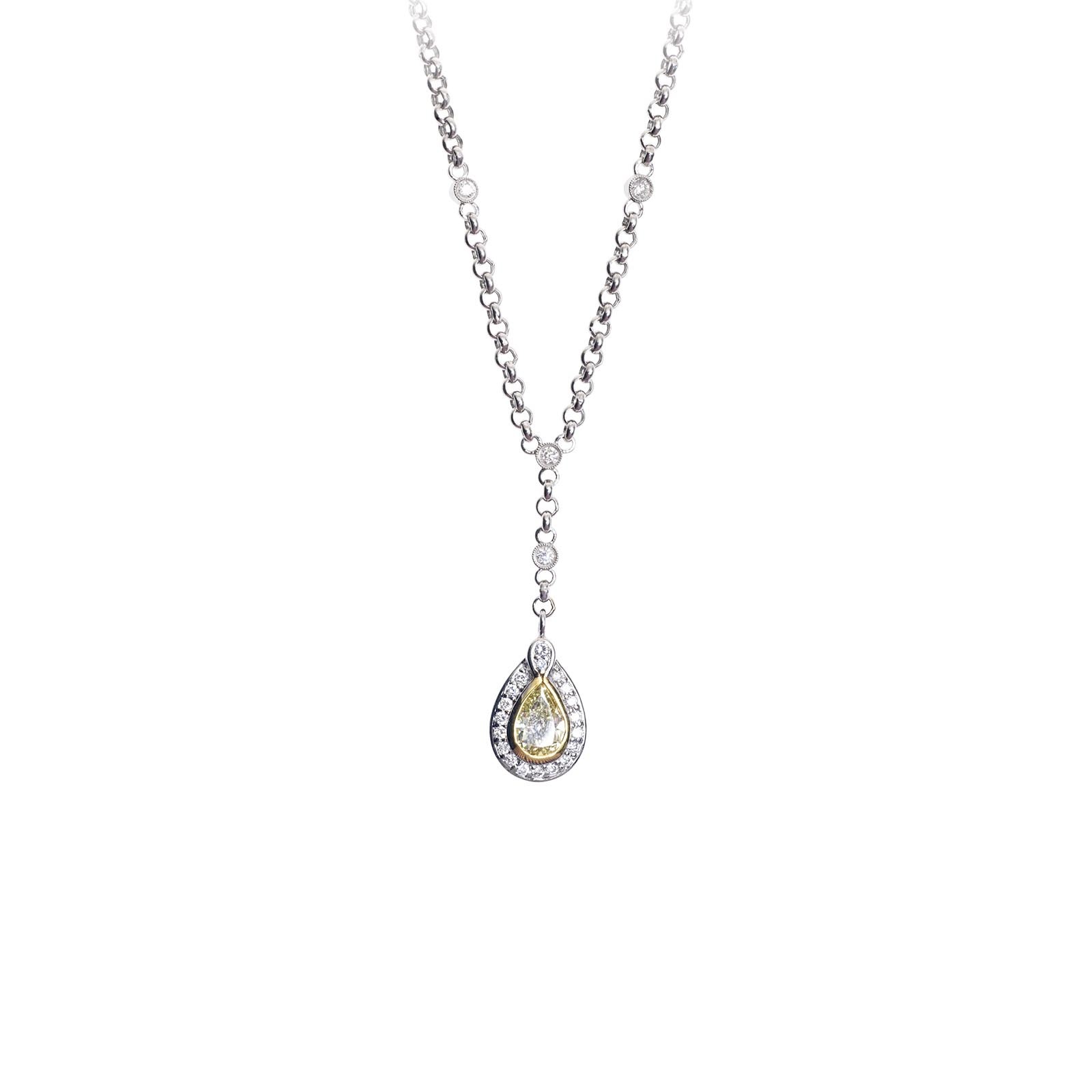 Pear shaped diamond pendant with diamond halo on a rolo chain.