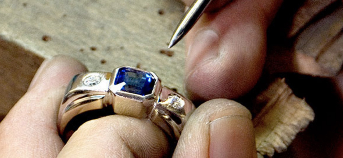 Bench jeweler working on production of a custom designed engagement ring.