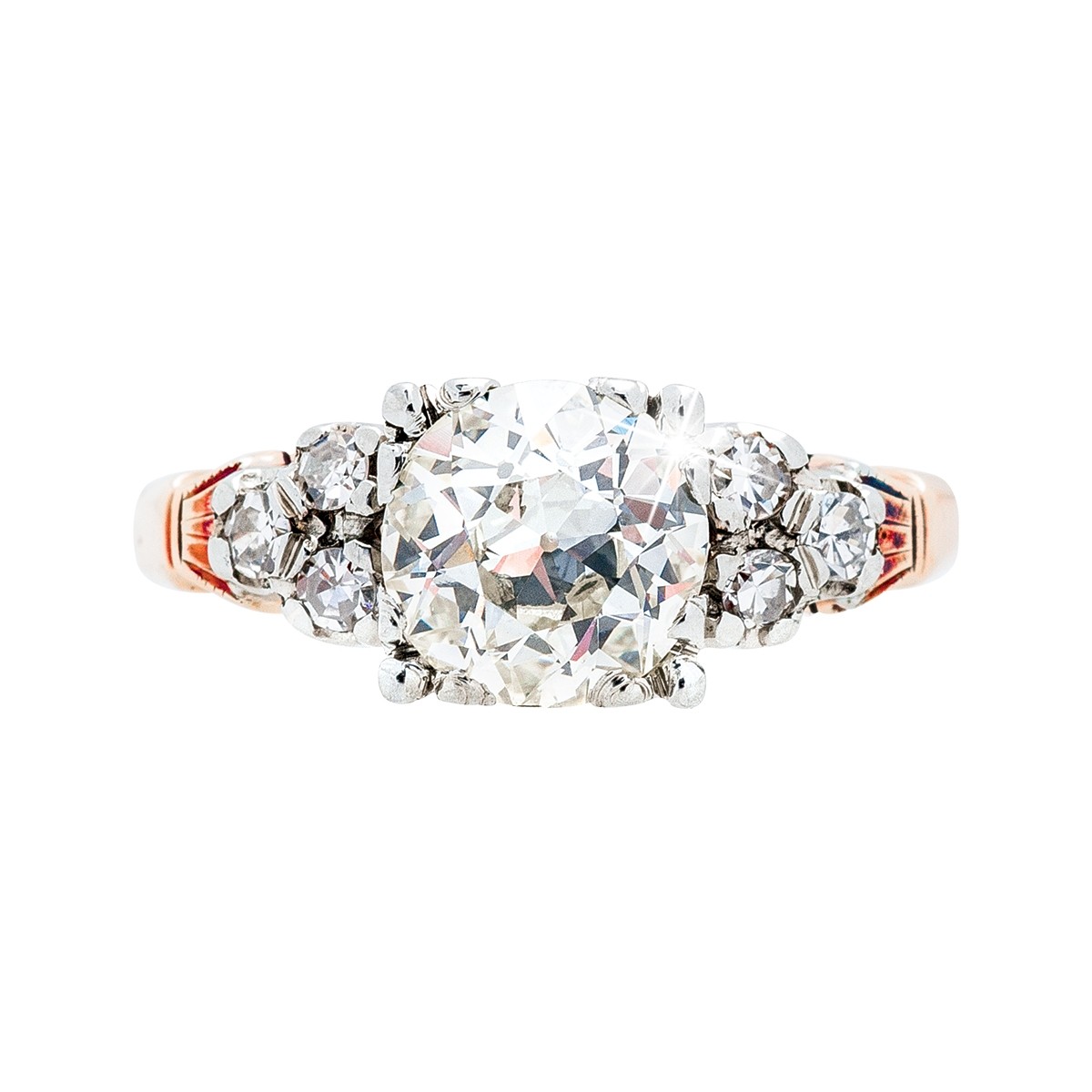 Rose gold engagement ring centered with a diamond surrounded by six smaller side stone diamonds.