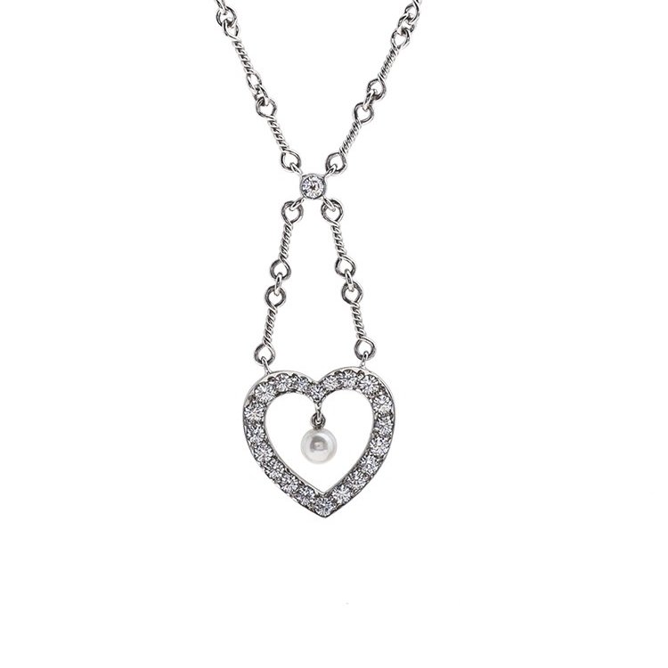Platinum heart necklace set with diamonds and a dangling pearl.