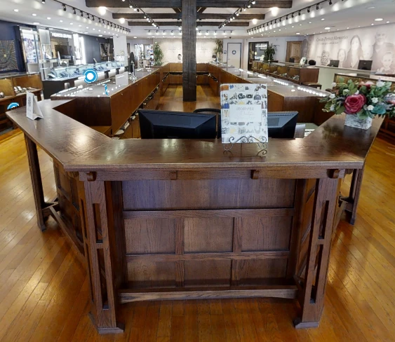 Panoramic view of Leo Hamel Fine Jewelers showroom featuring our 40 cases of fine jewelry, engagement rings, and watches