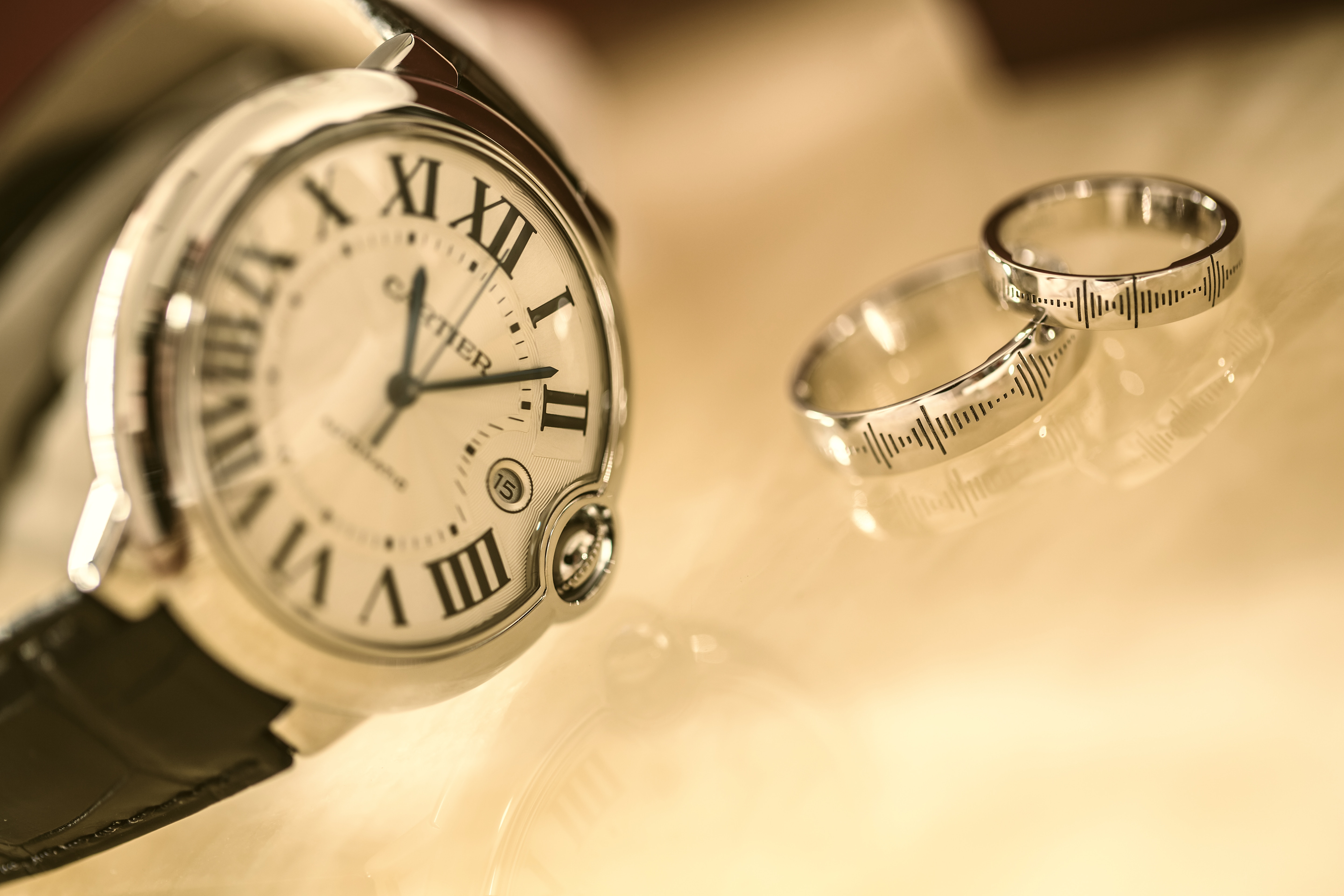 Pre-owned Cartier watch paired with two vintage designer rings.