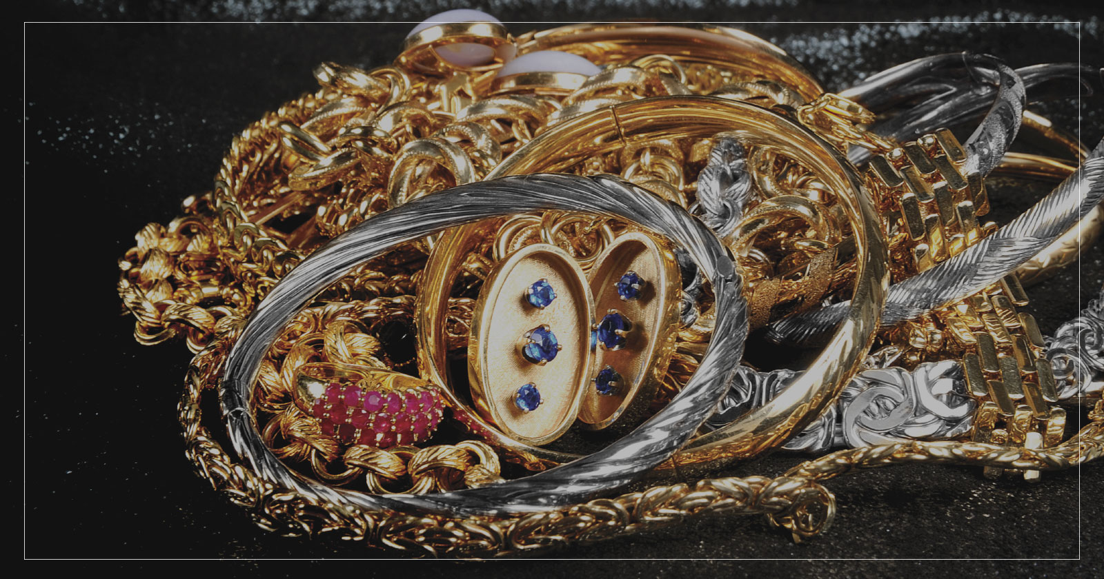 Assortment of white and yellow gold jewelry in a pile.