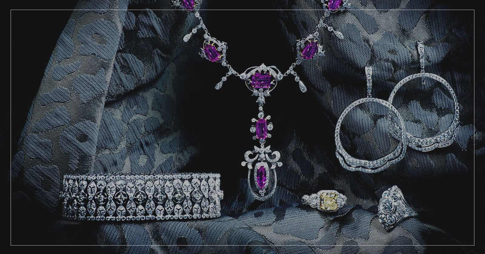 Group of diamond and gemstone jewelry including a bracelet, necklace, pair of earrings, and two rings.