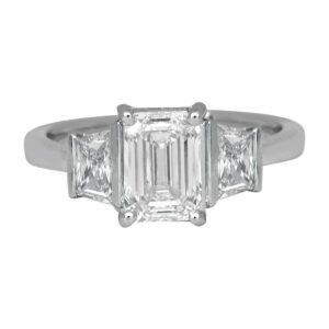 white gold 3-stone diamond ring centered with an emerald cut flanked by trapezoid cut diamonds