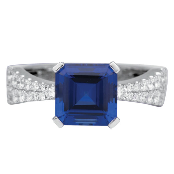 white gold ring centered with a blue asscher cut sapphire with diamonds in the band