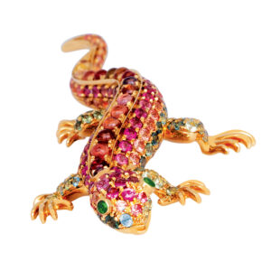 yellow gold lizard brooch set with pink, orange, and green sapphires