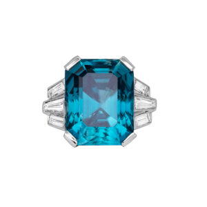 large blue zircon emerald cut flanked by trapezoid and baguette diamonds