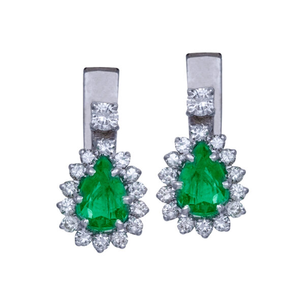 white gold earrings set with pear shaped emeralds and small diamond haloes