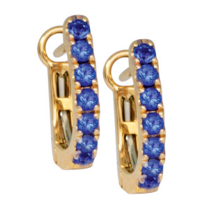 yellow gold huggie hoops set with round blue sapphires