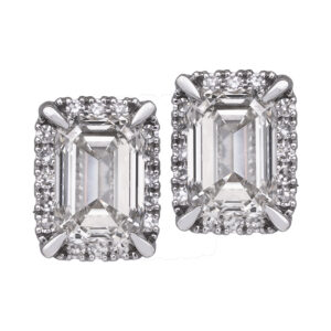 white gold earrings with emerald cut diamonds surrounded by round brilliant diamond haloes