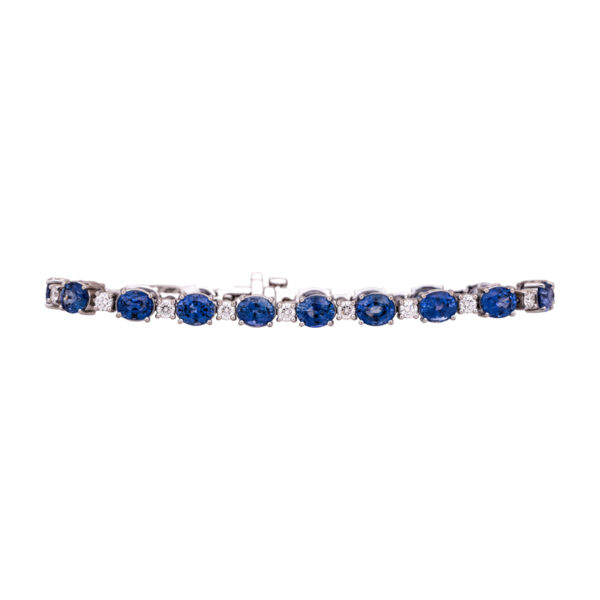 white gold tennis bracelet set with oval blue sapphires and round brilliant white diamonds