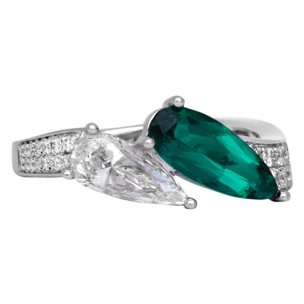 white gold 2-stone ring with a pear shaped emerald and pear shaped diamond, with diamonds in the band