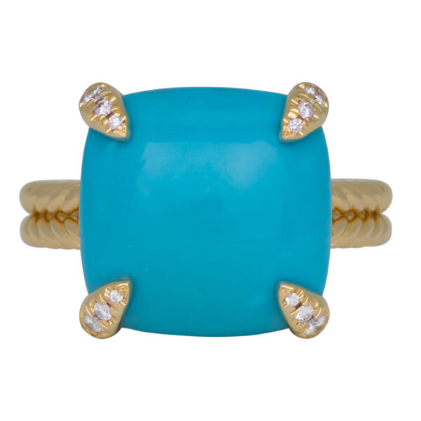 yellow gold ring with a square cushion cabochon turquoise and round brilliant diamonds set into the prongs