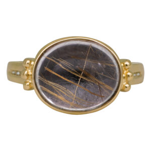 yellow gold ring with a rutilated quartz cabochon