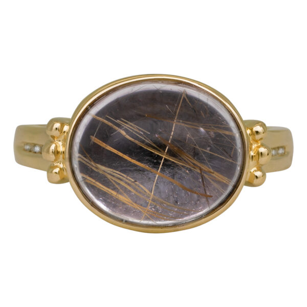 yellow gold ring with a rutilated quartz cabochon