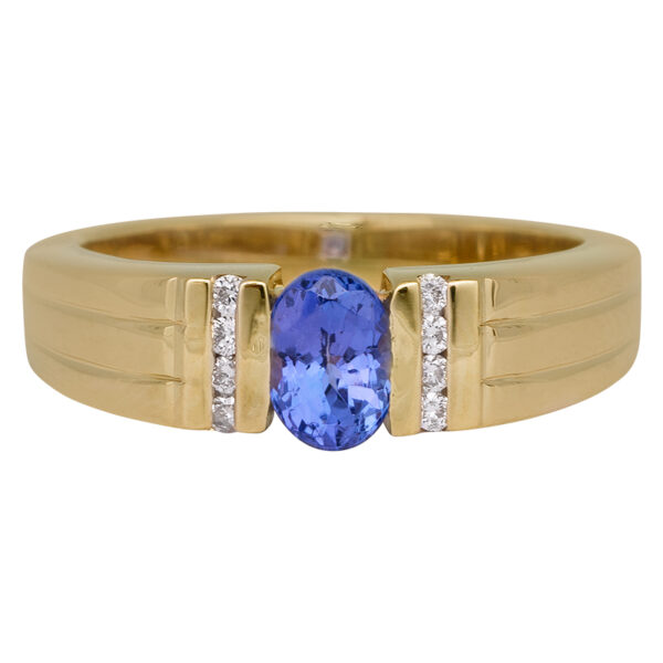 yellow gold band centered with an oval tanzanite and flanked by very small round diamonds