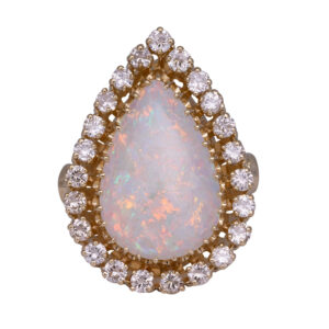 yellow gold halo ring set with a pear cut opal surrounded by a halo of round brilliant diamonds