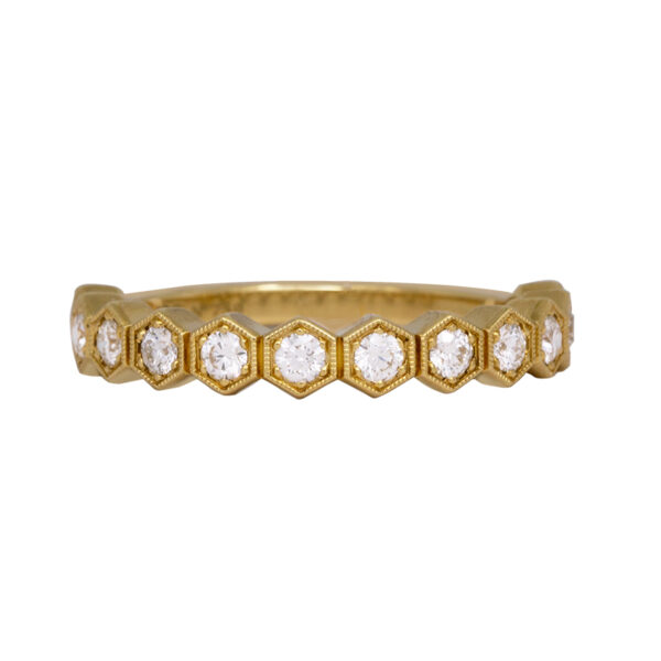 yellow gold wedding band set with round brilliant diamonds in hexagon shaped bezels