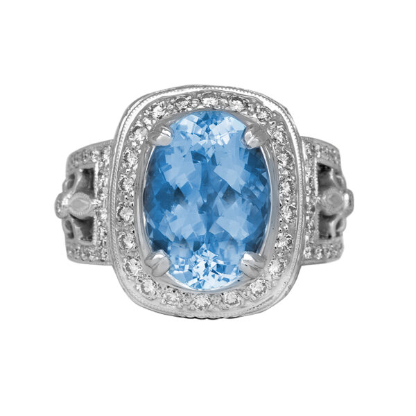 white gold halo ring centered with an oval aquamarine surrounded by a diamond halo