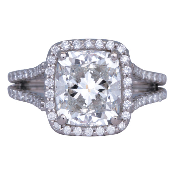 white gold halo engagement ring set with a large cushion diamond surrounded by a diamond halo and diamonds in the band