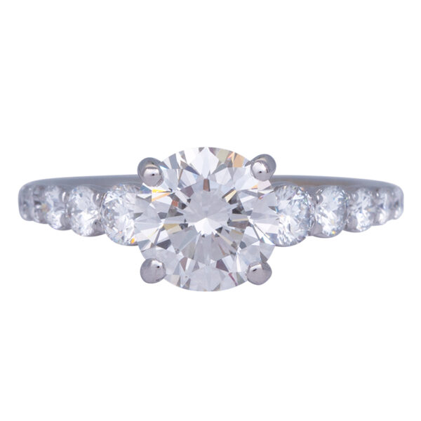 white gold tapered engagement ring centered with a round brilliant diamond and graduated diamonds in the band