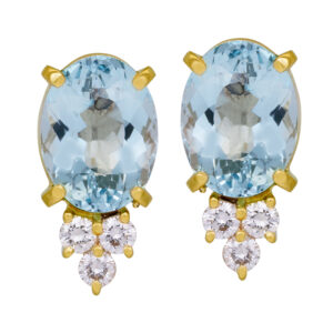 yellow gold stud earrings set with oval aquamarine and round brilliant diamonds hanging below them