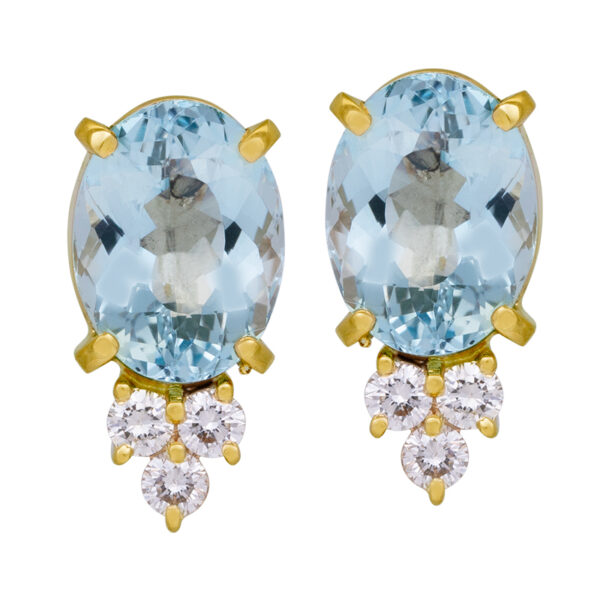 yellow gold stud earrings set with oval aquamarine and round brilliant diamonds hanging below them