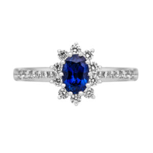 white gold oval blue sapphire surrounded by a diamond halo and diamonds in the band