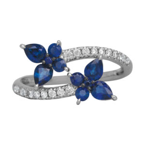 white gold bypass ring with blue sapphire clusters in the shape of two butterflies, with round diamonds in the band