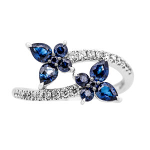 white gold bypass ring with diamonds and blue sapphires in the shape of butterflies