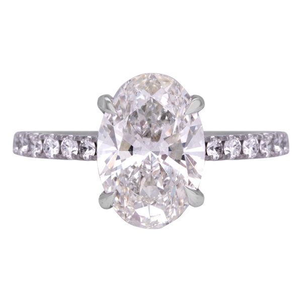 white gold engagement ring set with an oval diamond and diamonds in the band